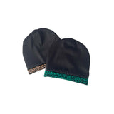 Two black beanies with patterned trim on a white background