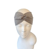 Gray headband on a mannequin head against a white background