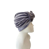Gray turban on a mannequin head against a white background