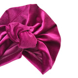 Purple headscarf with a large bow on a white background
