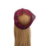 Maroon lace headband on a mannequin head with blonde hair against a white background