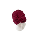 Maroon headscarf on a mannequin head against a white background