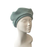 Light blue beanie on a mannequin head against a white background