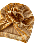 Gold velvet turban on a white background