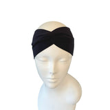 Black headband on a mannequin head against a white background