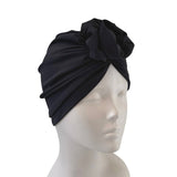 Black headscarf on a mannequin head against a white background