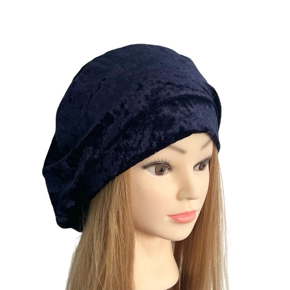 Navy blue textured headscarf on a mannequin head with long brown hair against a white background
