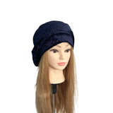 Navy blue headscarf on a mannequin head with long brown hair against a white background
