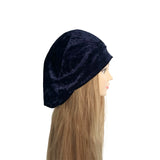 Navy blue beanie on a mannequin head with long blonde hair against a white background