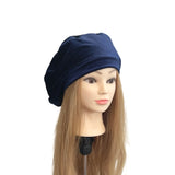 Mannequin head with long brown hair wearing a navy blue beanie on a white background