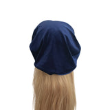 Navy blue headscarf on a mannequin head with blonde hair against a white background