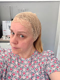 Person wearing a beige lace headband in an indoor setting