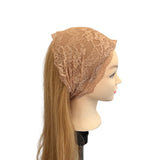 Mannequin head wearing a beige lace headscarf on a white background