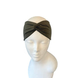 Green headband on a mannequin head against a white background