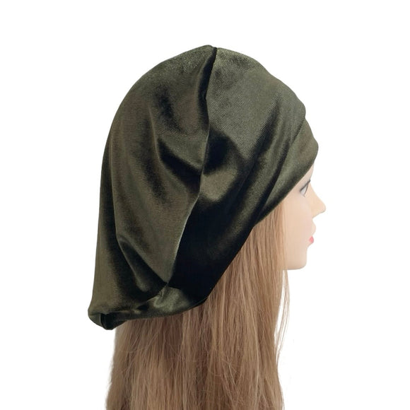 Mannequin head wearing an olive green headscarf on a white background