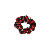 Red and black patterned scrunchie on a white background