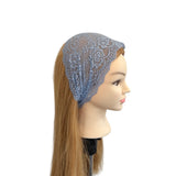 Mannequin head with a blue lace headband on a white background