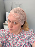 Person wearing a lace headband in a room with medical equipment.