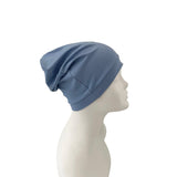 Blue headscarf on a mannequin head against a white background