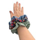 Hand wearing a colorful scrunchie on a white background ireland