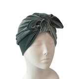 Green headscarf with a knot on a mannequin head against a white background ireland