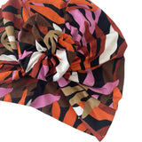 Colorful patterned headscarf with abstract design on a white background