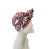 Colorful patterned headscarf on a mannequin head against a white background