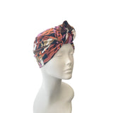 Colorful patterned headscarf on a mannequin head against a white background