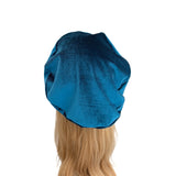 Blue satin hair bonnet on a mannequin head with blonde hair against a white background