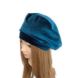 Blue headscarf on a mannequin head with long brown hair against a white background