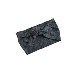 A black and gray leopard print headband with a large front bow, shown on a plain white background.