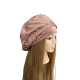Pink velvet headband on a mannequin head with long brown hair against a white background