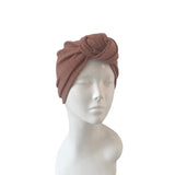 Brown headscarf on a mannequin head against a white background