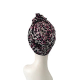 Leopard print headscarf on a mannequin head against a white background