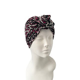 Leopard print headband on a mannequin head against a white background