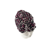 Leopard print headscarf on a mannequin head against a white background