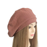 Pink knit beanie on a mannequin head with a white background