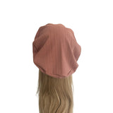 Brown wig cap with a wig on a white background