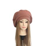 Mannequin head with a brown ribbed beanie on a white background