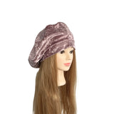Mannequin head with a pink velvet beret on a white background