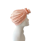Pink headscarf on a mannequin head against a white background
