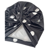 Dark gray satin hair turban with white polka dots on a white background