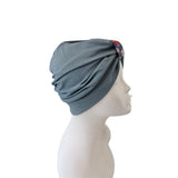 Gray headscarf on a mannequin head against a white background