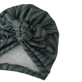 Green and black patterned headscarf with a knot on a white background