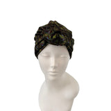 Turban with feather pattern on a mannequin head against a white background