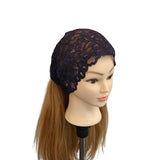 Mannequin head with a black lace headband on a white background