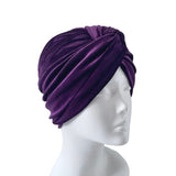 Purple turban on a mannequin head against a white background