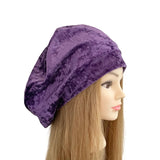 Purple headscarf on a mannequin head with long brown hair against a white background