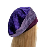 Purple velvet bonnet on a mannequin head with blonde hair against a white background ireland