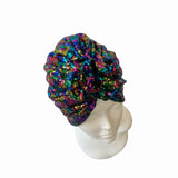 Multicolored sequin head wrap on a mannequin head against a white background